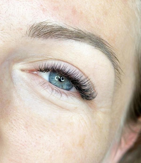 Lash extensions and brows on blue eyes
